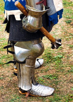 Medieval knight rests his war hammer after battle