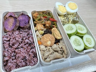 Stir-fried chicken with spicy tofu, boiled eggs, brown rice and baked purple potatoes