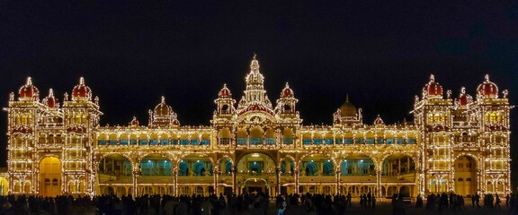 Illuminated facade of the Mysore Palace at night, India.