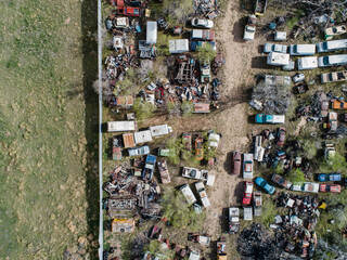 Junk yard aerial photo with room for print.  Shows neglected antique cars and trucks.   Environmental catastrophe. 
