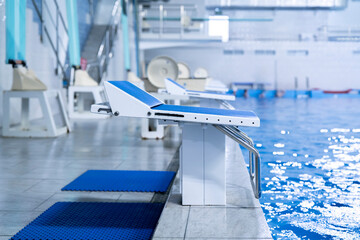blue starting block in the swimming pool, sport swim olympic kind of sport - obrazy, fototapety, plakaty
