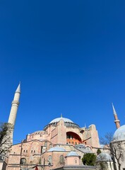 Fototapeta na wymiar Hagia Sophia Grand Mosque against the background of a bright blue sky. Istanbul, Turkey.