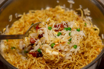 Traditional biro biro rice with peas, bacon, egg, straw potatoes and aromatic herbs