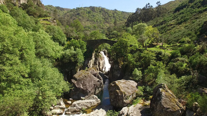 Aerial Shot of Stunning Nature Landscape in Portugal. Waterfall in the Mountains. Misarela Bridge 