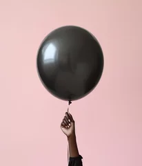 Foto op Canvas Black female hand holding a balloon © Lina