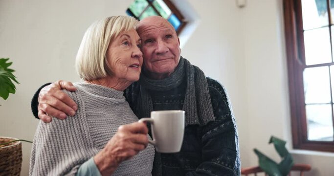 Kiss, senior couple and coffee in home, love and bonding together in morning in winter. Romance, elderly man and woman with tea cup, drink and healthy relationship, connection and hug for support