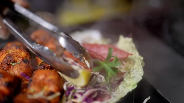 tasty hot meat meals in restaurant, closeup view, cook decorated dish by lemon piece