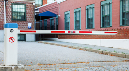 parking lot gate framed by soft sunlight, symbolizing access, security, and the transition from the...