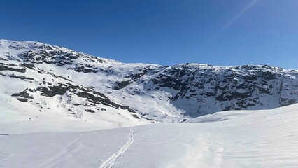 Scenic view of a snow-covered mountain slope, with a clear sky