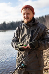 Fototapeta premium fisherman fishing on the river bank, Fishing rod, spinning