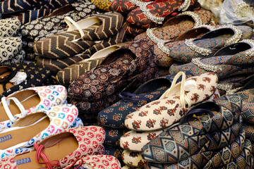 Colorful Handmade chappals (sandals) being sold in an Indian market, Handmade leather slippers, Traditional footwear.