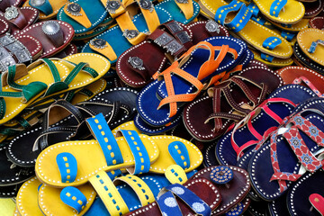 Colorful Handmade chappals (sandals) being sold in an Indian market, Handmade leather slippers,...