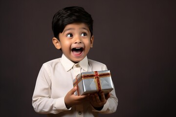 A heartwarming moment of a indian child receiving a surprise gift box, their face lighting up with joy and wonder, solid background