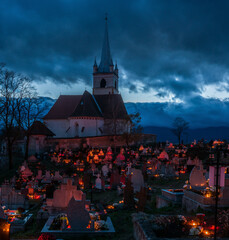 Night cemetery on All Saints' Day in Romani, Transylvania. Grave lights on All Saints' Day.- 672856949