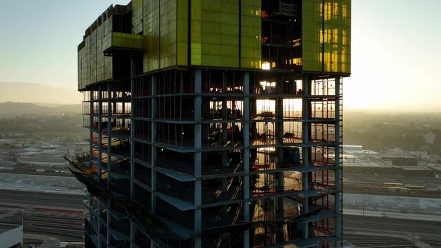 Aerial shot of a new high-rise building under construction at sunrise