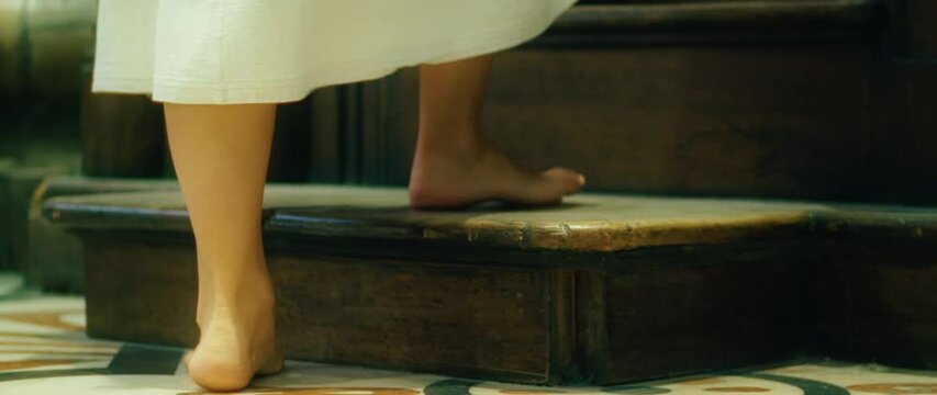 Confession of sins to a priest. The woman came to the priest to repent. Repentance for sins. Barefoot pilgrim tramp praying in church.