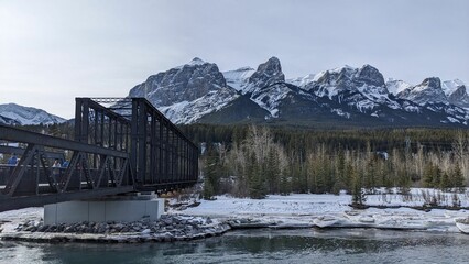 Bridge over the river surrounded by Rocky Mountains in Canmore, Alberta