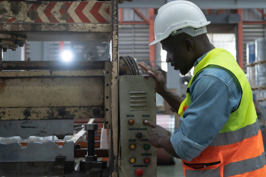 Male worker working with machinery, working at factory warehouse Employees working in industrial warehouses worker wearing a helmet