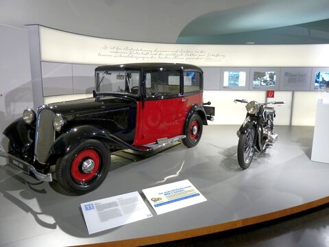 Munich, Germany - June 16, 2016:   A classical BMW 303 car and motorcycle models of 1930s at the BMW Museum exhibition