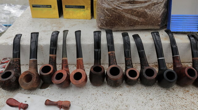 Set of artisanal, wooden, tobacco smoking pipes, market stall in the Pazari i Ri-New Bazaar, Old Town. Tirana-Albania-005