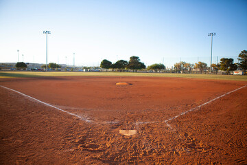 Empty baseball field view from home plate, late afternoon light