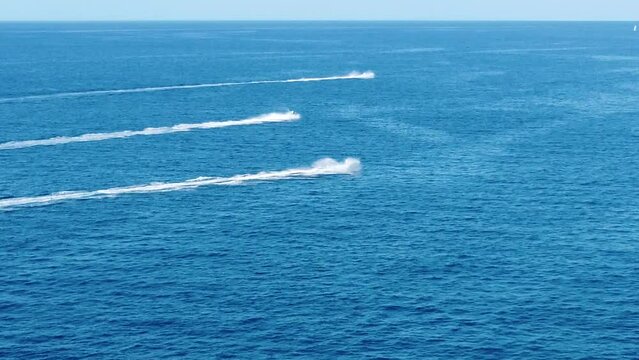 unrecognizable people on jetsky and a few boats