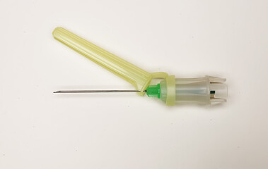 Closeup of one isolated disposable safety injection cannula needle with plastic glide