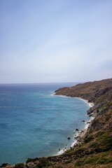Naklejka na ściany i meble Scenic view of the ocean coastline of Saint George Beach in Ikaria, Greece.