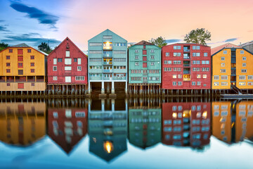 Colorful old houses over the Nidelva river at summer sunset in Trondheim, Norway