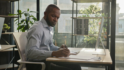 African american mature senior businessman 50s ethnic man sit in sun shining sunlight office banker...