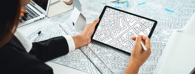 Worker, architect and engineer work on real estate construction project oratory planning with cartography and cadastral map of urban town area to guide to construction developer business plan of city