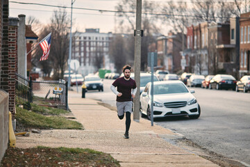 Obraz premium Young man running in American street