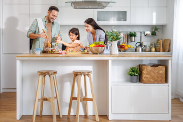 Happy family cooking together in kitchen