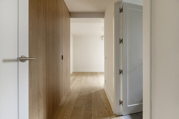 Small entrance hallway to a modern designed bedroom with custom-made built-in wardrobe with light...