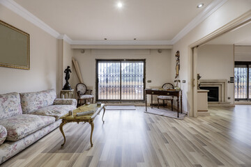 One-bedroom suite living room with wooden floors, terrace with sliding doors, railings, vintage furniture and fireplace in the kitchen