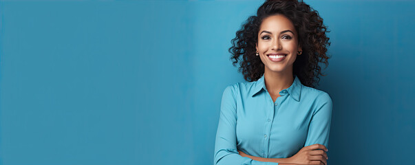 Hispanic nice woman standing in front of blue wall or background.