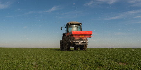  tractor fertilizing in field