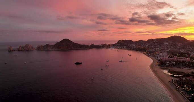 Glorious Red Sky Sunrise Over Cabo Mexico Bay with Yachts and City Beach