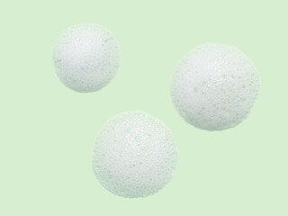 Skincare cleanser foam texture with bubbles isolated on green background. Soap shampoo face wash cleansing musse product sample