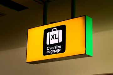 Oversize baggage drop area at the airport. Air travel, airport signage concept.