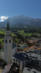 Fototapeta na wymiar a church tower on a roof overlooking a large mountain range