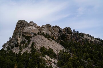 Fototapeta premium Scenic view of Mount Rushmore with lush green trees on the slope. United States.