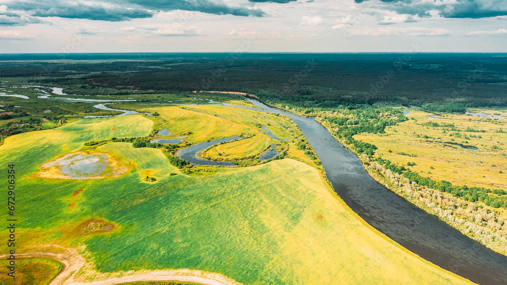 Poster Drone Aerial View Spring Meadow Field Pasture And Curved River Marsh. Springtime Landscape. Top View From High Attitude In Summer Season. Drone View, . Bird's Eye View. Ecological Concept Background. - Posters