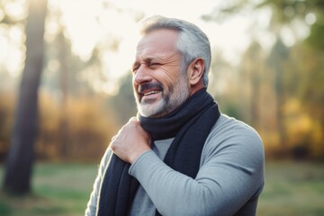 Fototapeta premium Shoulder pain. Mature man suffering from arthritis in the shoulder joint Holding your sore shoulder