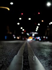 a street filled with lots of cars at night under the headlights