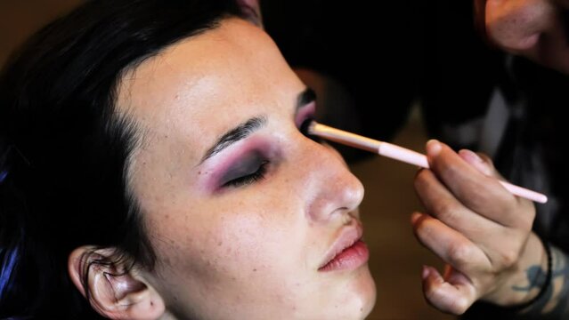 young woman holding mascara apply on eyeleashes prepare getting ready in the morning, smiling beautiful girl doing make up put cosmetics and lipstik on face looking in mirror in dressing room