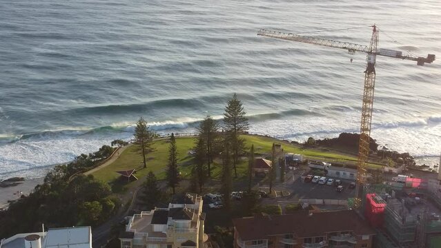 Drone footage of  town houses, crance and buildings by sea coast with sunset sky