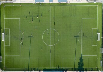 View of a soccer field in Canada, with players actively participating in a match © Wirestock