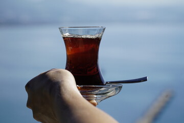 Turkish tea, served in the typical way, in an original small glass in front of the Mediterranean...
