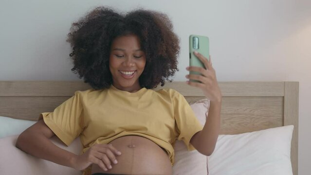 Joyful African Mom Shows Ultrasound to Family from Bed
